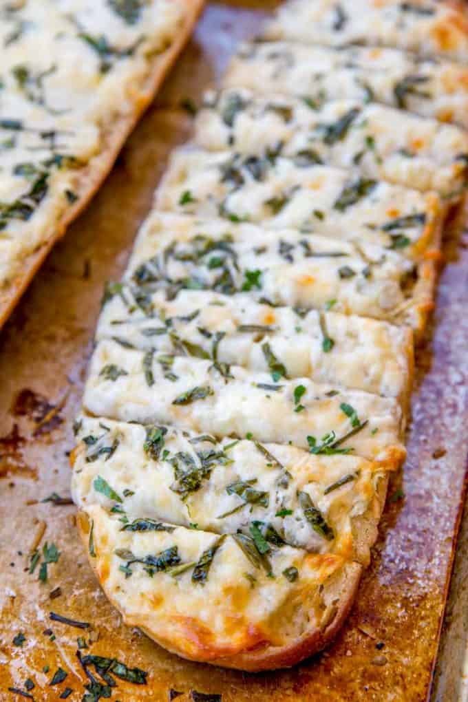 Spinach Artichoke Dip Cheesy Bread is two of your favorite appetizers in one. Cheesy garlic bread meets spinach and artichoke dip in just 30 minutes!