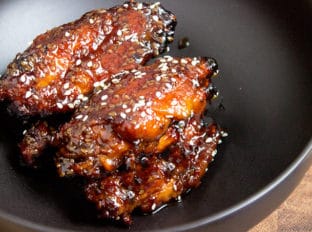 Sticky Asian chicken wings made with a hoisin take on a Mongolian beef marinade. They're sweet, savory, garlicky, just plain awesome and basically begging to be made for your Superbowl party!