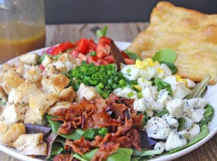Cosi Cobb Salad with grilled chicken, bacon, eggs, gorgonzola and more topped with Cosi's signature Sherry Shallot Vinaigrette dressing.