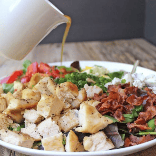 Cobb Salad with grilled chicken, bacon, eggs, gorgonzola, and more, topped with Vinaigrette dressing.