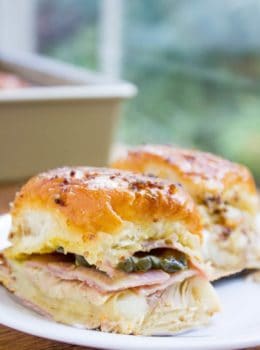 Baked Cuban Pork Party Sliders have pork shoulder, sliced ham, Swiss cheese, pickles, brown mustard and a butter whole grain mustard topping make these party sliders a perfect gameday treat and put the standard ham and cheese versions to shame.