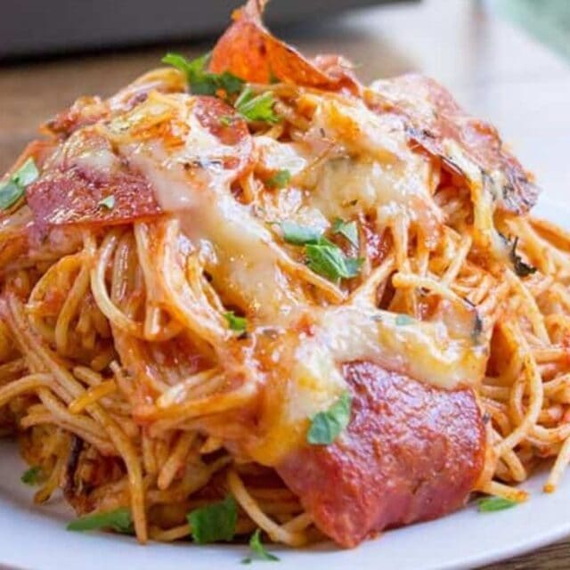 Large plate of cheesy spaghetti and pepperoni