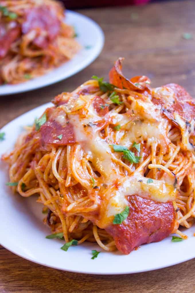 A mix of pepperoni pizza and cheesy marinara pasta, this Easy Baked Pepperoni Pizza Spaghetti is a fun alternative to pizza night and perfect for a crowd! dinnerthendessert.com