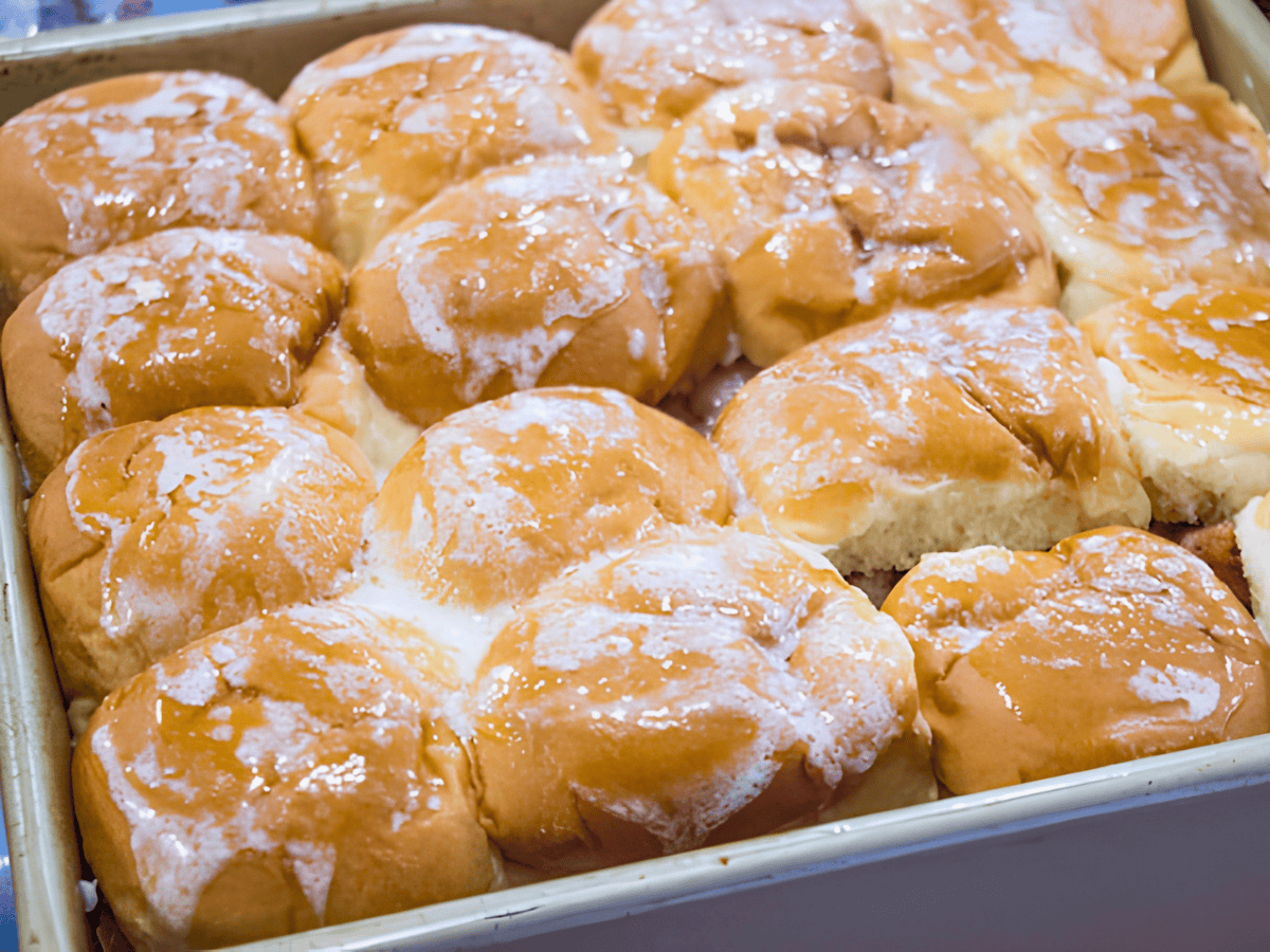 sweet buns lined up in a baking pan