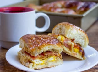 Baked Bacon Egg and Cheese Hawaiian Sliders are quick to make. They're a perfect make ahead and bake the morning of option for get togethers and can quickly serve a crowd!