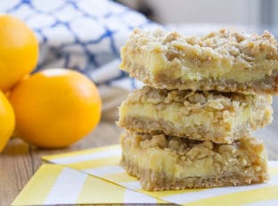 Easy Creamy Lemon Crumb Bars with a quick oatmeal crumb base and a sweet and tart creamy lemon filling.