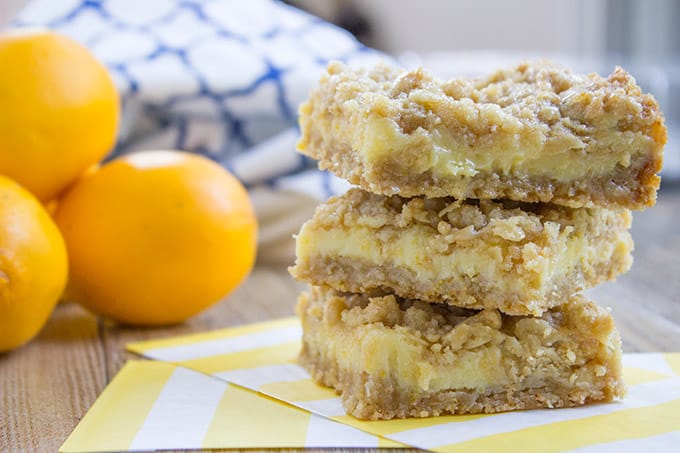 Easy Creamy Lemon Crumb Bars with a quick oatmeal crumb base and a sweet and tart creamy lemon filling.