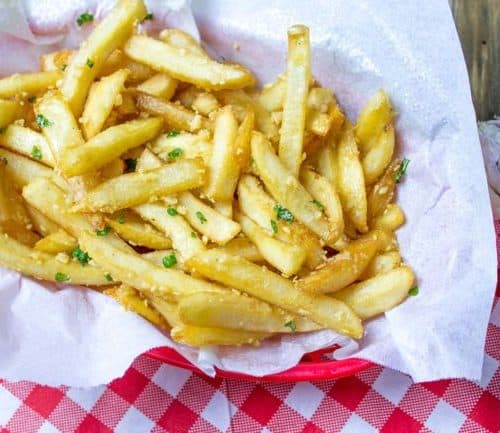 Oven Baked Loaded Garlic French Fries tossed in slightly warmed chopped garlic, olive oil and kosher salt, just like you enjoy at the ball game!