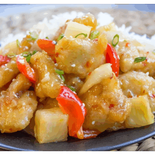 sliced chicken, peppers, veggies, and rice on a plate