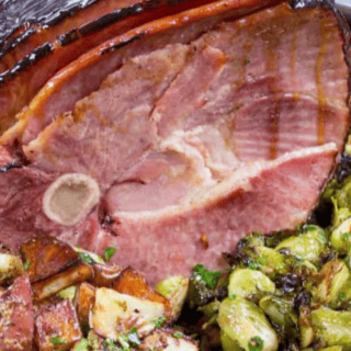 Close up of ham with sprouts and potatoes