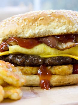 Carl's Jr. Breakfast Burger with seared beef patty, crispy hash browns, scrambled eggs, cheese and glorious bacon. All the flavor, no drive-thru.