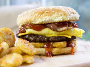 Carl's Jr. Breakfast Burger with seared beef patty, crispy hash browns, scrambled eggs, cheese and glorious bacon. All the flavor, no drive-thru.