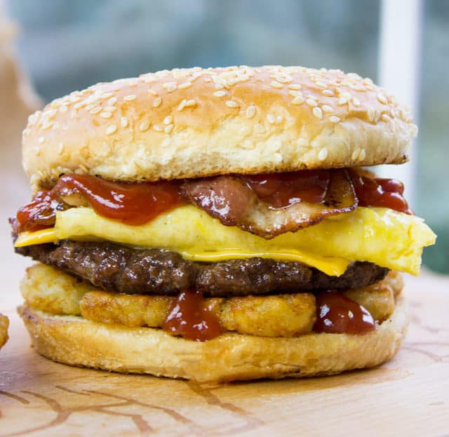 Carl's Jr. Breakfast Burger with seared beef patty, crispy hash browns, scrambled eggs, cheese and glorious bacon. All the flavor, no drive through.