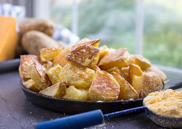 Cheddar and Sour Cream Roasted Potatoes in bowl with scoop