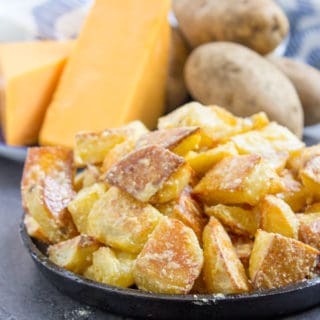 Roasted Potatoes in bowl with ingredients in background