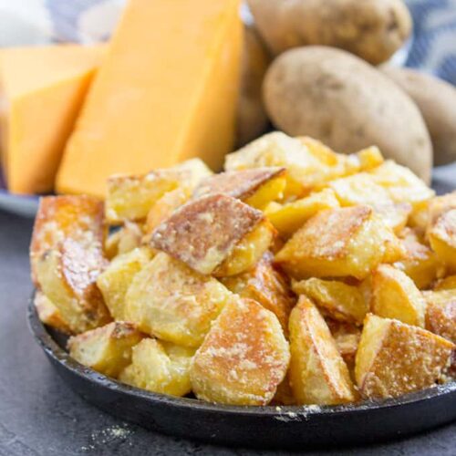 Roasted Potatoes in bowl with ingredients in background