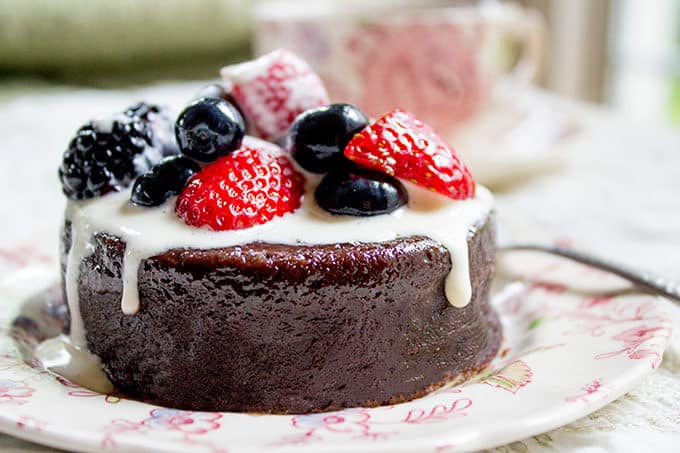 Flourless Mocha Cake with Creme Anglaise on plate with fresh berries