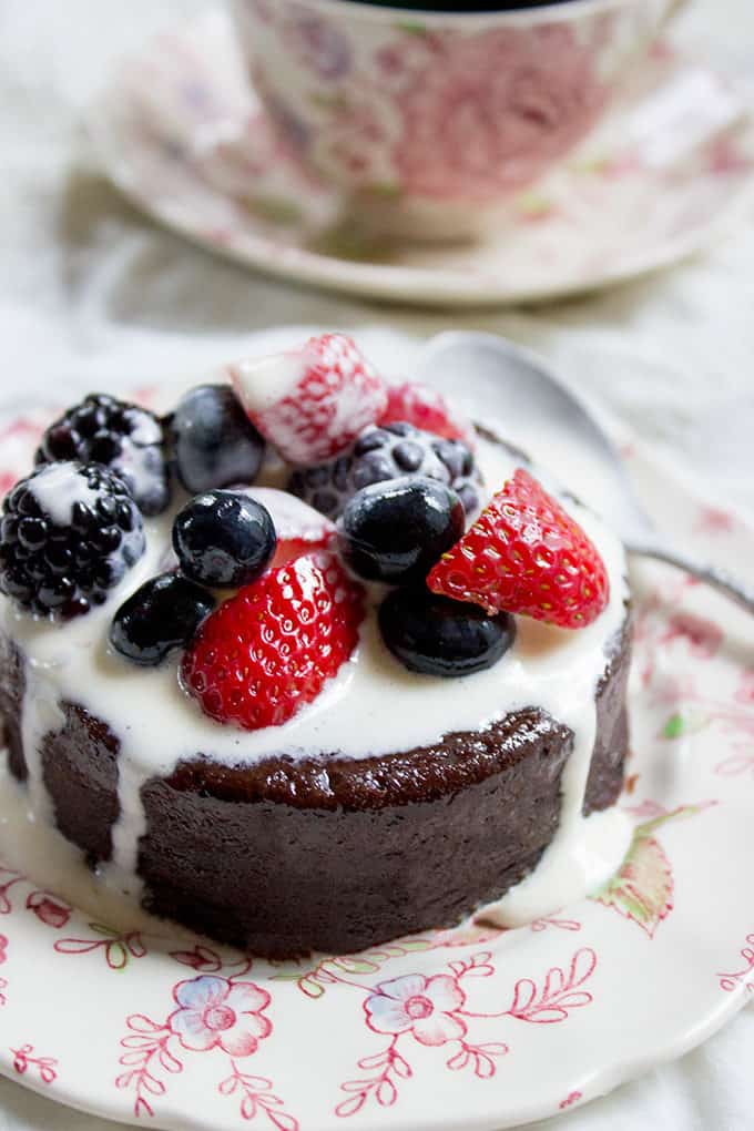 Flourless Mocha Cake with Creme Anglaise on plate with fresh berries.
