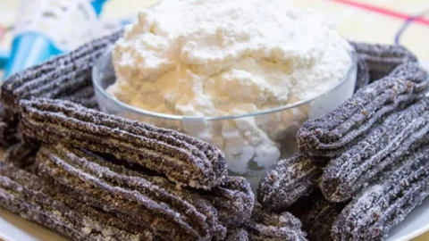plated churros with whipped cream
