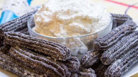 pile of churros made of oreo on plate with dipping