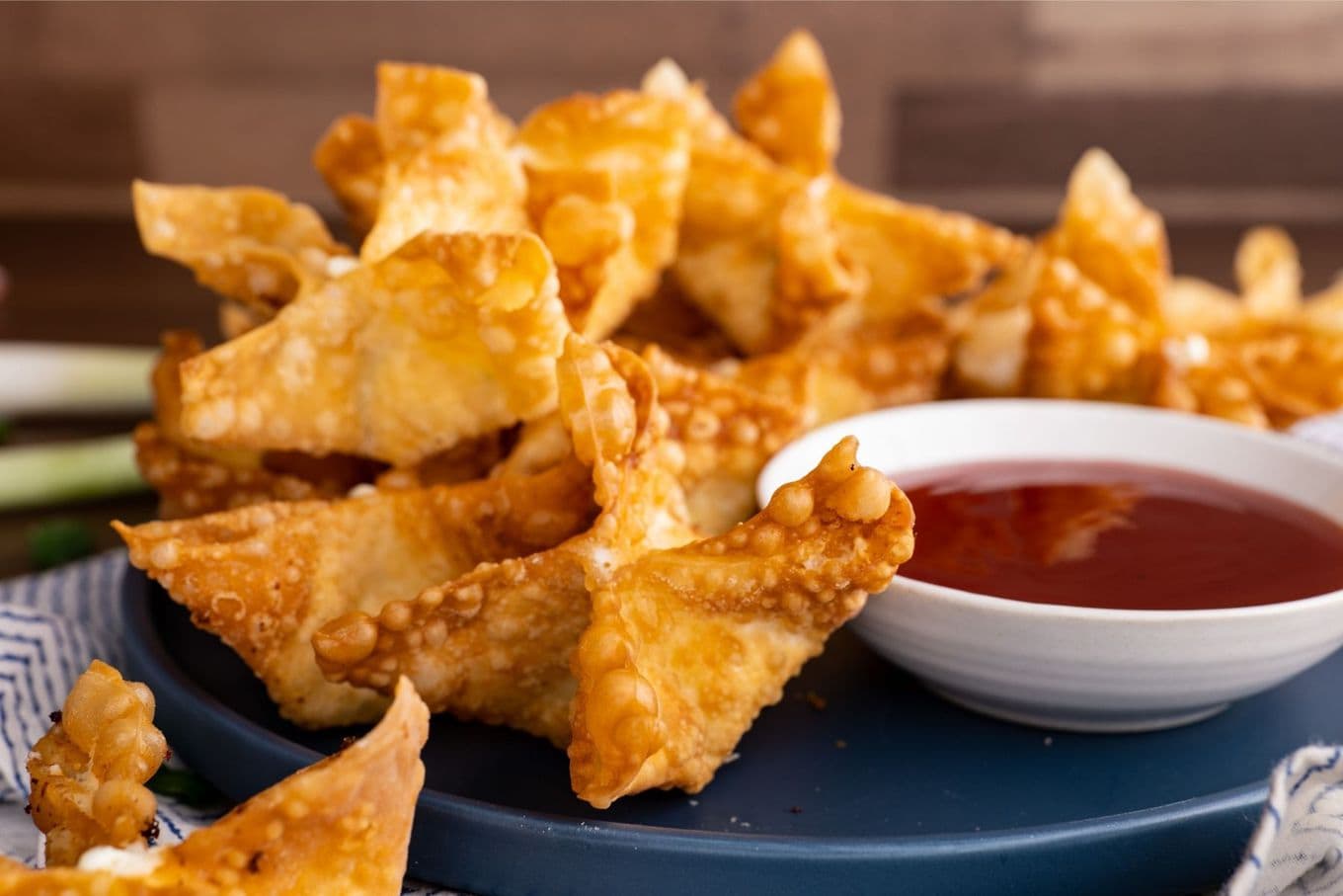 Panda Express Cream Cheese Rangoon on serving plate with dipping sauce