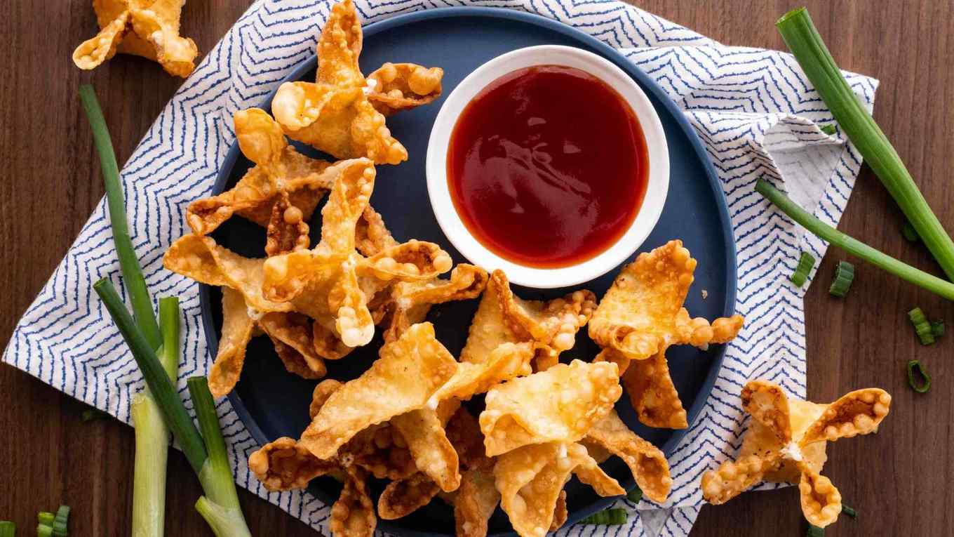 Panda Express Cream Cheese Rangoon on serving plate with dipping sauce