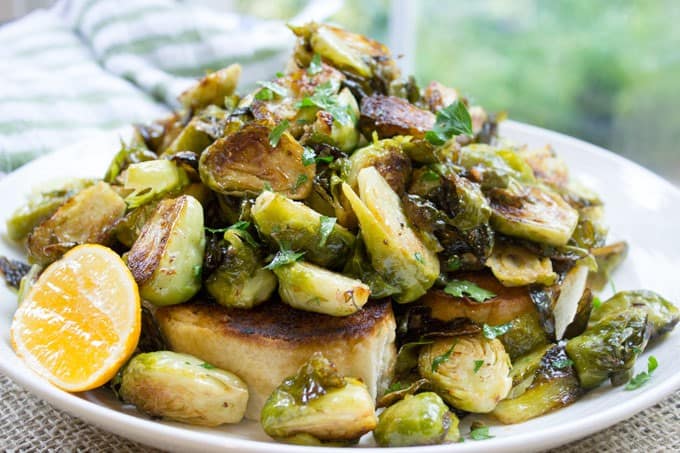 Tin Roof Bistro Brussels Sprouts are caramelized and tossed in a lemony caper butter sauce. The most popular item on the menu will make anyone a fan!