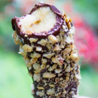 Chocolate covered banana with bite taken out
