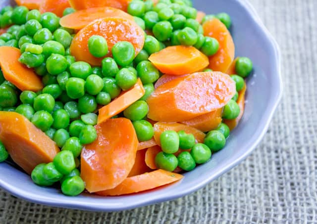 blue bowl of carrots and peas