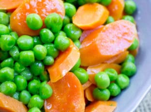 Classic Buttered Carrots and Peas made in just one bowl in a microwave and just five minutes using fresh carrots and frozen sweet green peas. A perfect bright side dish to your favorite meal.