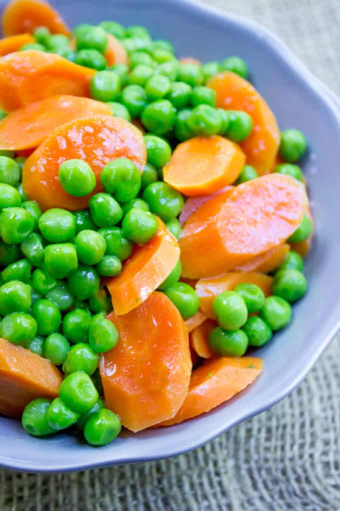 Classic Buttered Carrots and Peas made in just one bowl in a microwave and just five minutes using fresh carrots and frozen sweet green peas. A perfect bright side dish to your favorite meal.
