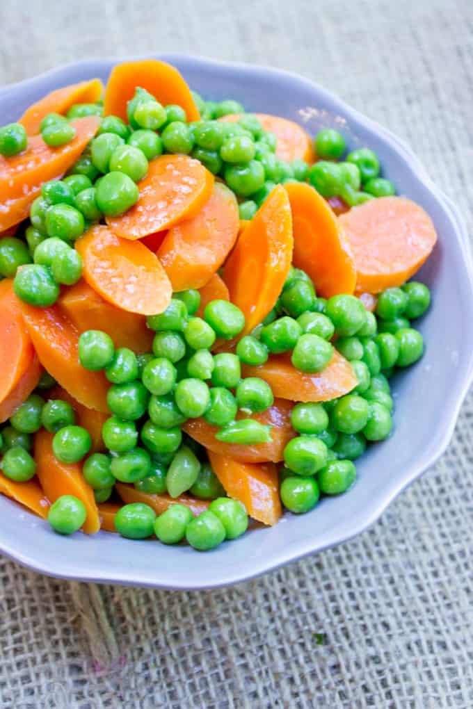 Classic Buttered Carrots and Peas made in just one bowl in a microwave and just five minutes using fresh carrots and frozen sweet green peas. A perfect bright side dish to your favorite meal.