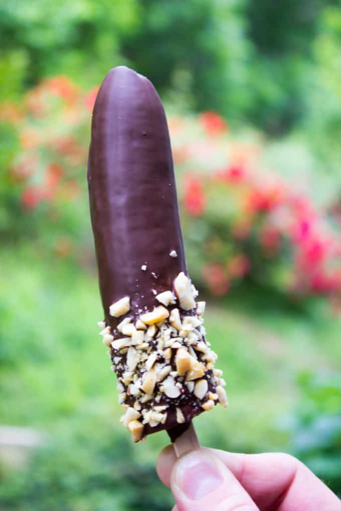 Chocolate coated banana with nuts at the bottom