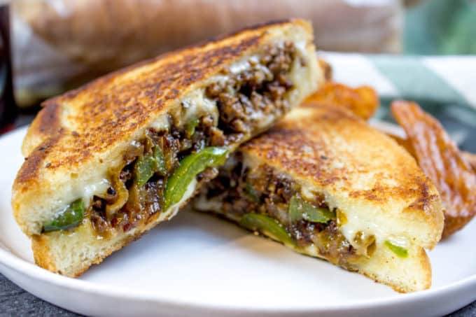 Ground Philly Cheesesteak Grilled Cheese made with bell peppers, onions and American or Provolone Cheese. All the flavor of a cheese steak for half the price.