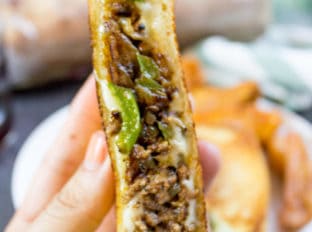 Ground Philly Cheesesteak Grilled Cheese made with bell peppers, onions and American or Provolone Cheese. All the flavor of a cheese steak for half the price.