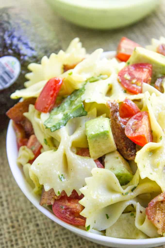 Avocado BLT Pasta Salad with avocados blended into a cilantro lime dressing and chunks for a delicious creamy bite with bacon, lettuce and tomatoes.