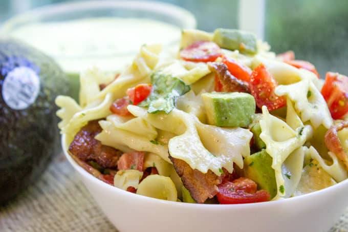 Avocado BLT Pasta Salad with avocados blended into a cilantro lime dressing and chunks for a delicious creamy bite with bacon, lettuce and tomatoes.