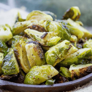 Crispy seasoned Brussels sprouts in a skillet.