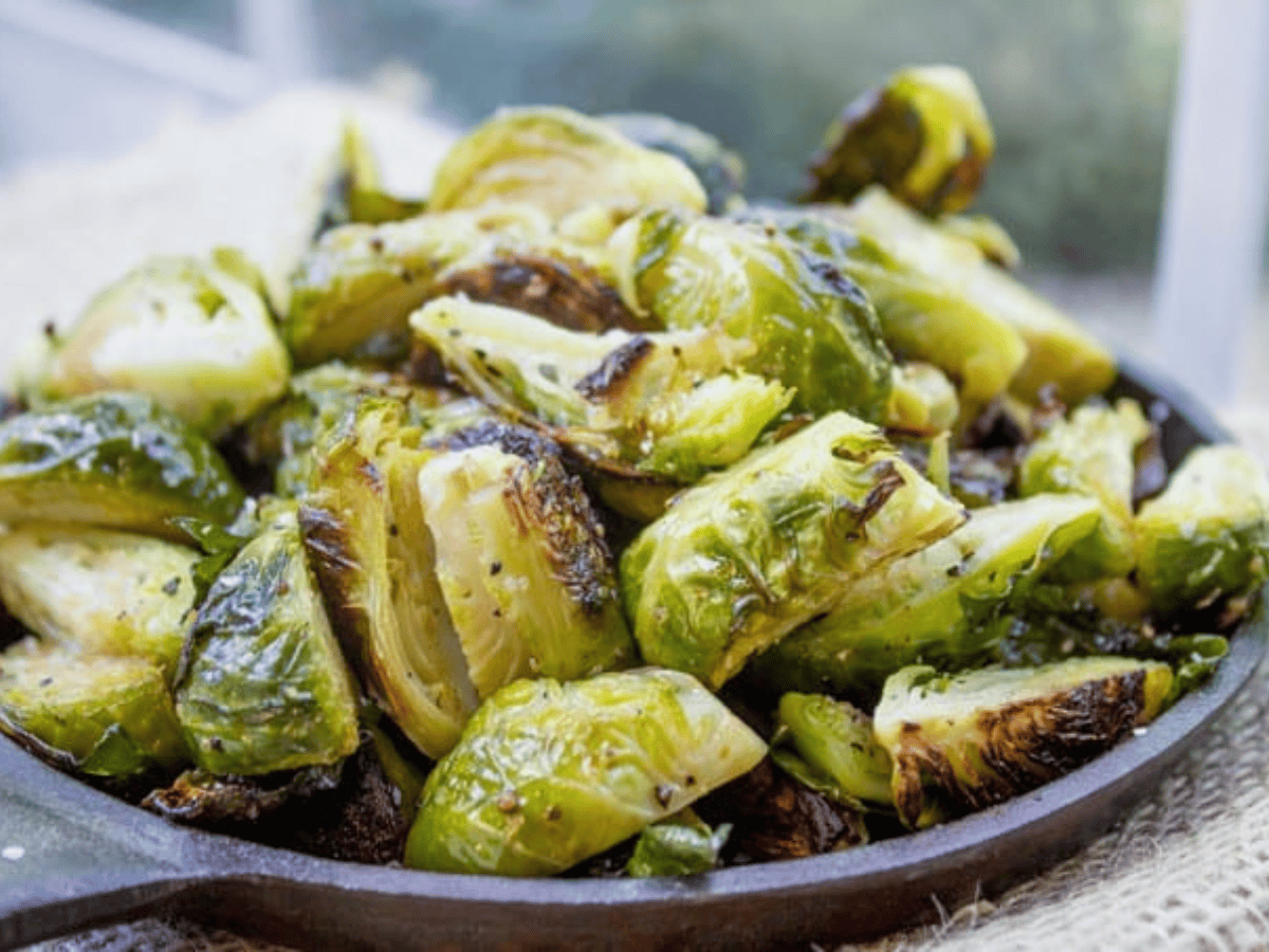 Crispy seasoned Brussels sprouts in a skillet.