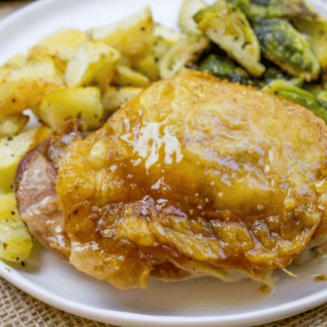 White plate with turkey thigh, potatoes and brussels sprouts