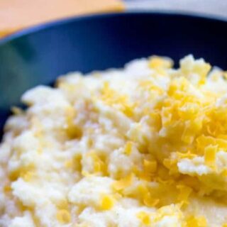 Polenta in a blue bowl, ready to serve.