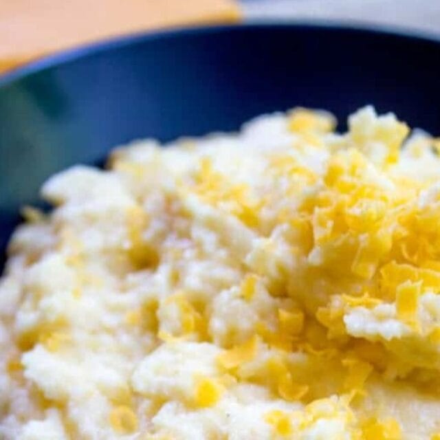 Polenta in a blue bowl, ready to serve.