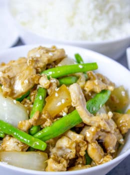 Panda Express String Bean Chicken Breast with onions cooked quickly in a wok in a light ginger soy sauce.