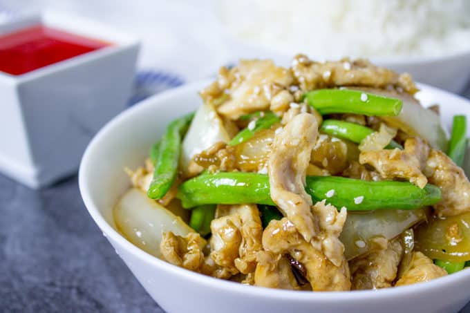 Panda Express String Bean Chicken Breast with onions cooked quickly in a wok in a light ginger soy sauce.