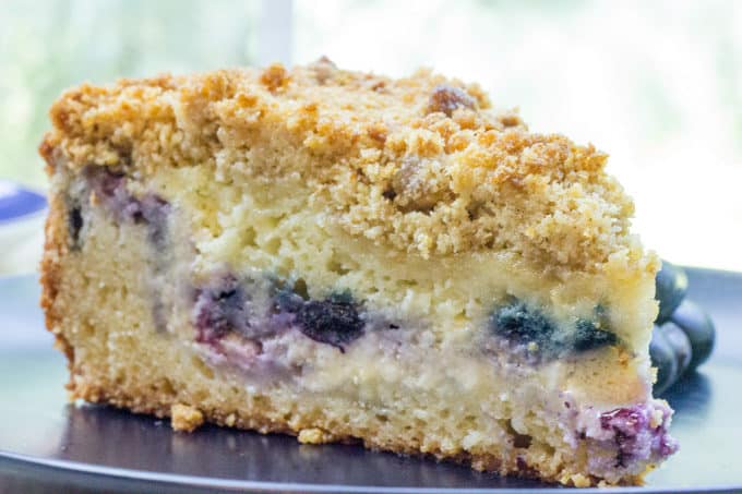 Blueberry Cream Cheese Coffee Cake with a tender center, creamy filling and a crunchy, buttery topping. A perfect mix of crumb coffee cake and cheesecake.