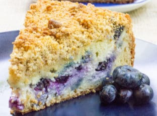 Blueberry Cream Cheese Coffee Cake with a tender center, creamy filling and a crunchy, buttery topping. A perfect mix of crumb coffee cake and cheesecake.
