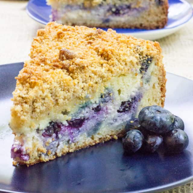 Blueberry Cream Cheese Coffee Cake with a tender center, creamy filling and a crunchy, buttery topping. A perfect mix of crumb coffee cake and cheesecake.