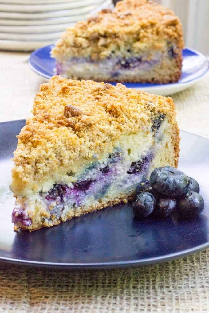 Blueberry Cream Cheese Coffee Cake with a tender center, creamy filling and a crunchy, buttery topping. A perfect mix of crumb coffee cake and cheesecake.