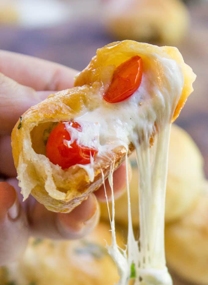 Caprese Pizza Bombs are a quick, fun treat or appetizer with fresh mozzarella, basil and cherry tomatoes. Plus the stretchy cheese factor is amazing.