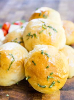 Caprese Pizza Bombs are a quick, fun treat or appetizer with fresh mozzarella, basil and cherry tomatoes. Plus the stretchy cheese factor is amazing.